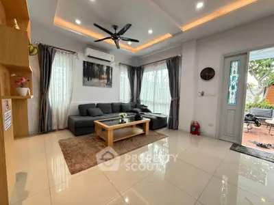Spacious living room with modern decor and large windows for natural light.