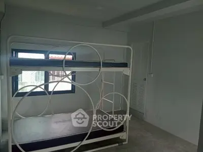 Minimalist bedroom with unique bunk bed and natural light from window