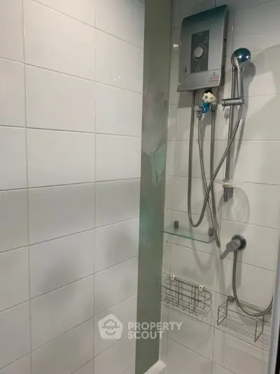 Modern bathroom shower with water heater and sleek tile design