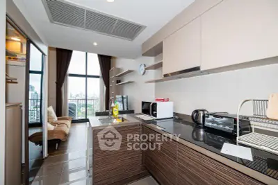 Modern kitchen with open layout and city view, featuring sleek appliances and stylish design.