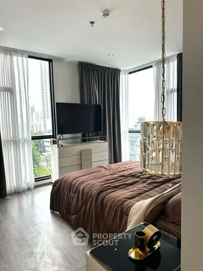 Luxurious bedroom with modern decor and large windows offering city views.