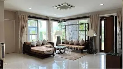 Spacious living room with modern furniture and large windows offering natural light