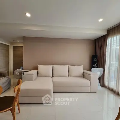 Modern living room with beige sectional sofa and elegant decor