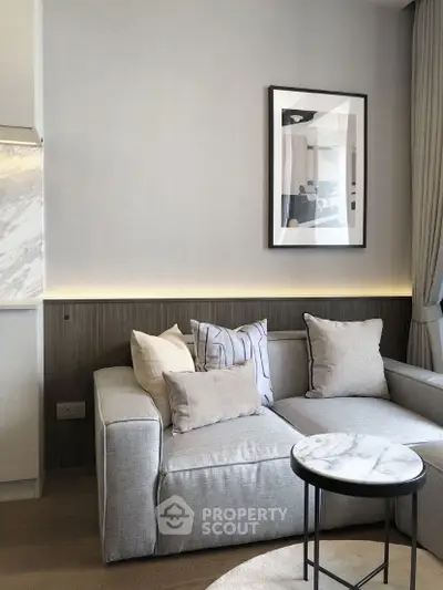 Stylish modern living room with cozy gray sofa and elegant marble side table.