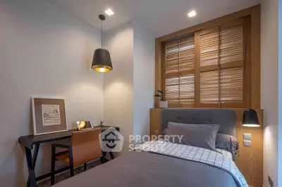 Cozy bedroom with modern decor and stylish lighting, perfect for a comfortable living experience.
