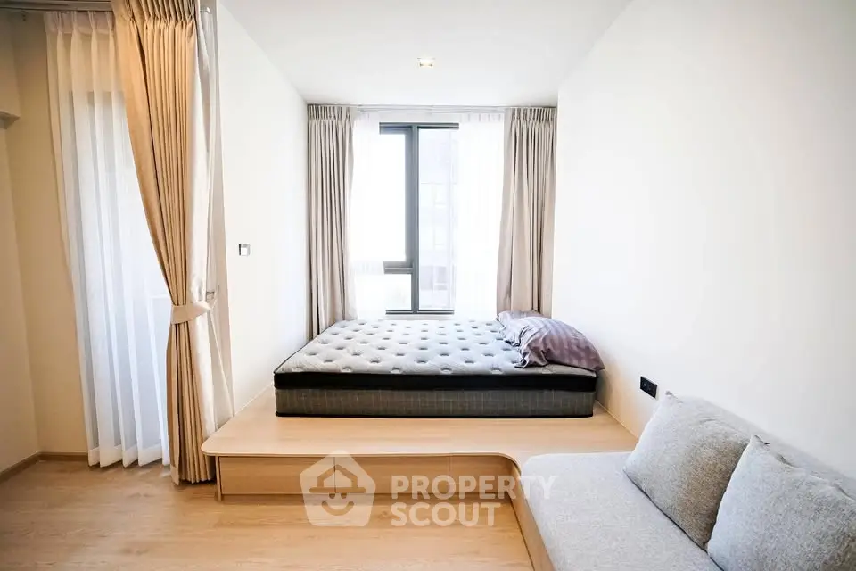 Modern minimalist bedroom with platform bed and natural light