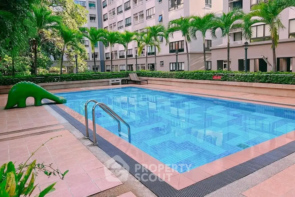 Luxurious residential pool area with tropical landscaping and modern design.