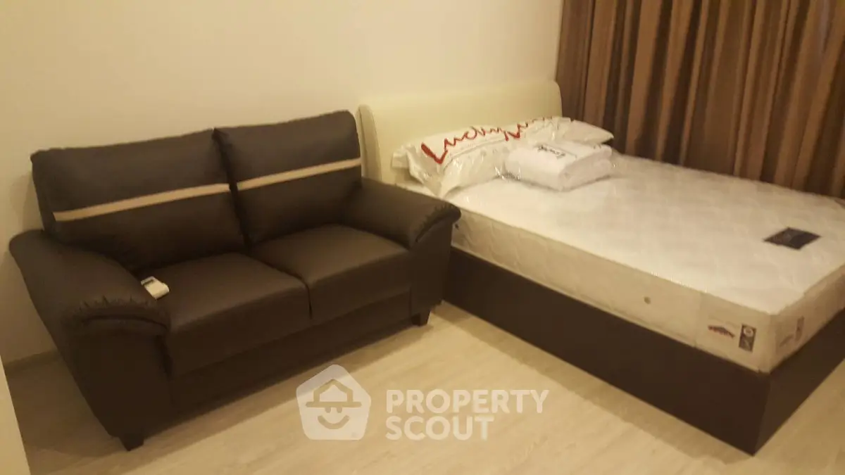 Cozy bedroom with a comfortable bed and stylish sofa, perfect for relaxation.