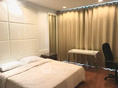 Spacious bedroom with elegant decor and natural light, featuring a comfortable bed and modern furnishings.