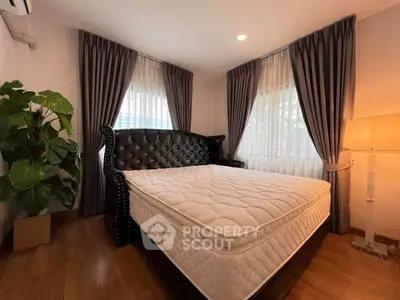 Cozy bedroom with elegant bed and natural light, perfect for relaxation.