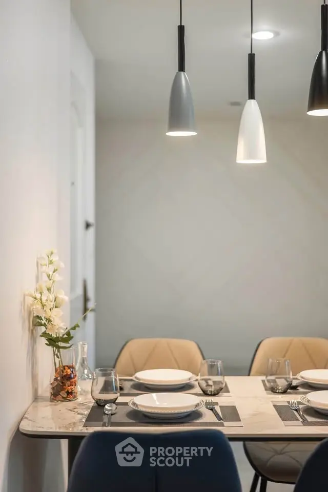 Modern dining area with elegant lighting and stylish table setting
