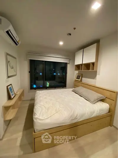 Modern bedroom with wooden bed frame and city view window, featuring minimalist decor and ambient lighting.