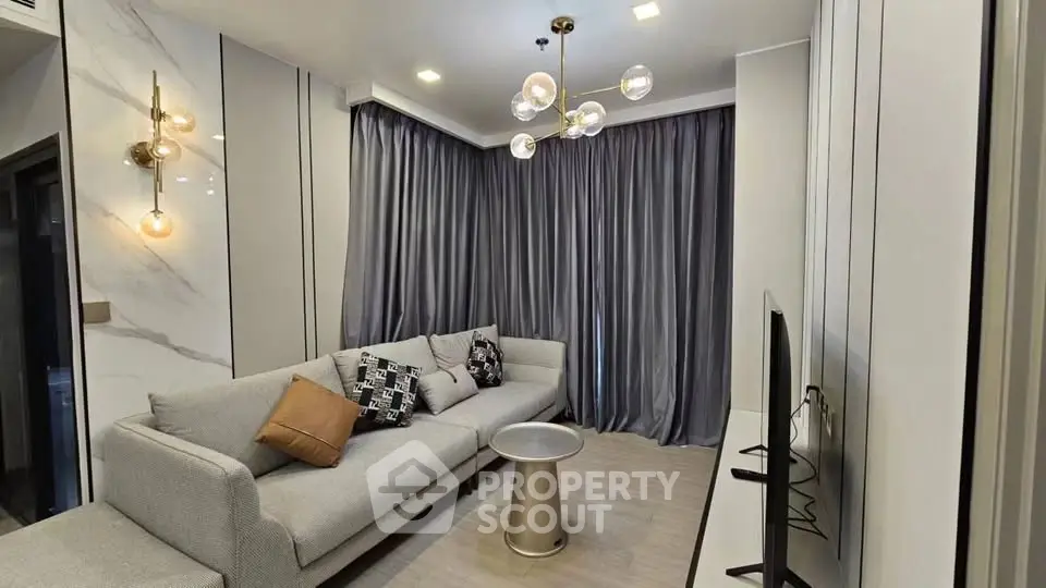 Modern living room with elegant lighting and cozy gray sofa