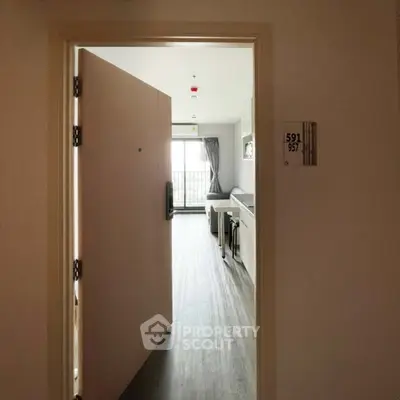 Modern apartment entrance with sleek flooring and bright natural light