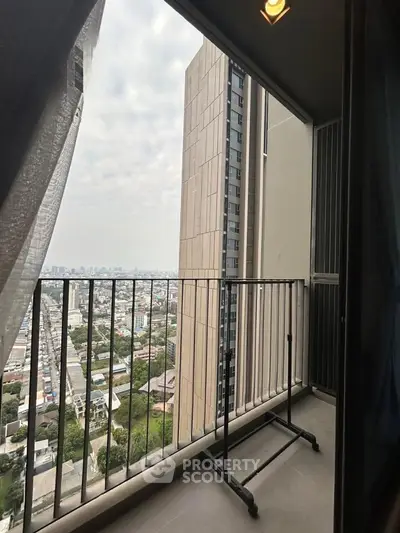 High-rise balcony with cityscape view, perfect for urban living enthusiasts.