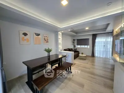 Modern open-plan living and dining area with stylish decor and natural light.