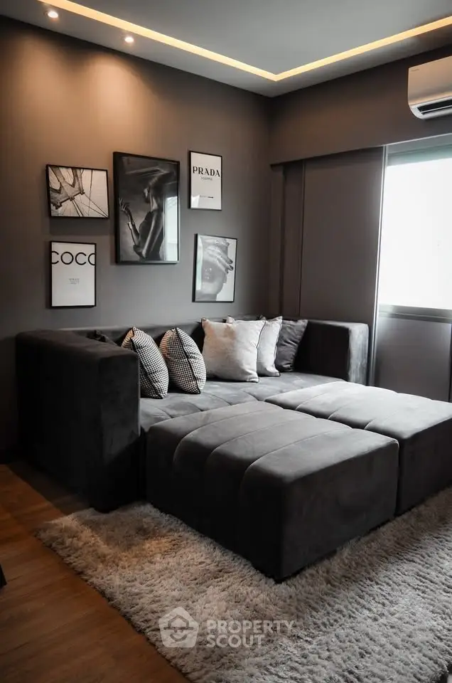 Luxurious modern living room with plush gray sectional sofa and stylish wall art.