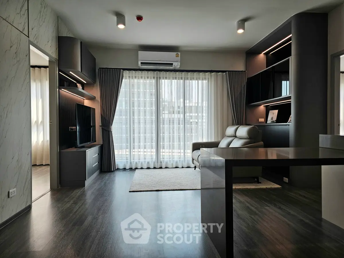 Modern living room with sleek design, large windows, and stylish furniture, perfect for urban living.