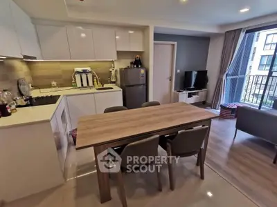 Modern kitchen and living area with open layout and balcony view