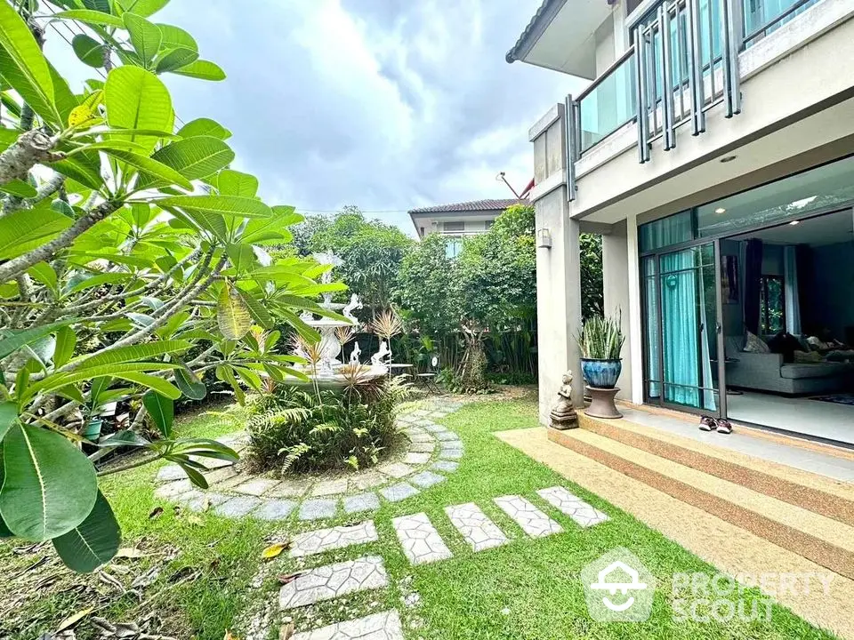 Charming garden view of modern home with lush greenery and spacious outdoor area.