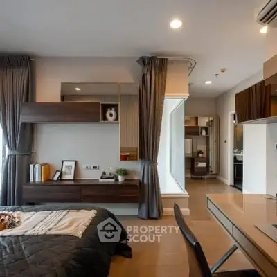 Modern bedroom with stylish decor and ample natural light in a contemporary apartment.