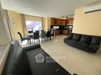 Spacious open-plan living room with modern kitchen and dining area