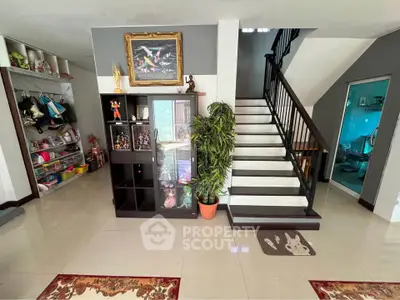 Spacious living area with staircase and modern decor, perfect for family gatherings.