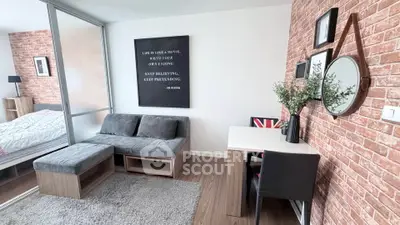 Stylish modern living room with cozy seating and workspace, featuring brick accent wall and decorative elements.