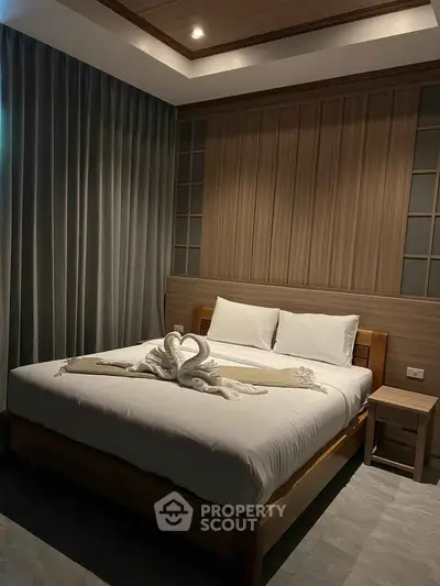 Luxurious bedroom with elegant decor and cozy ambiance, featuring a stylish bed and soft lighting.