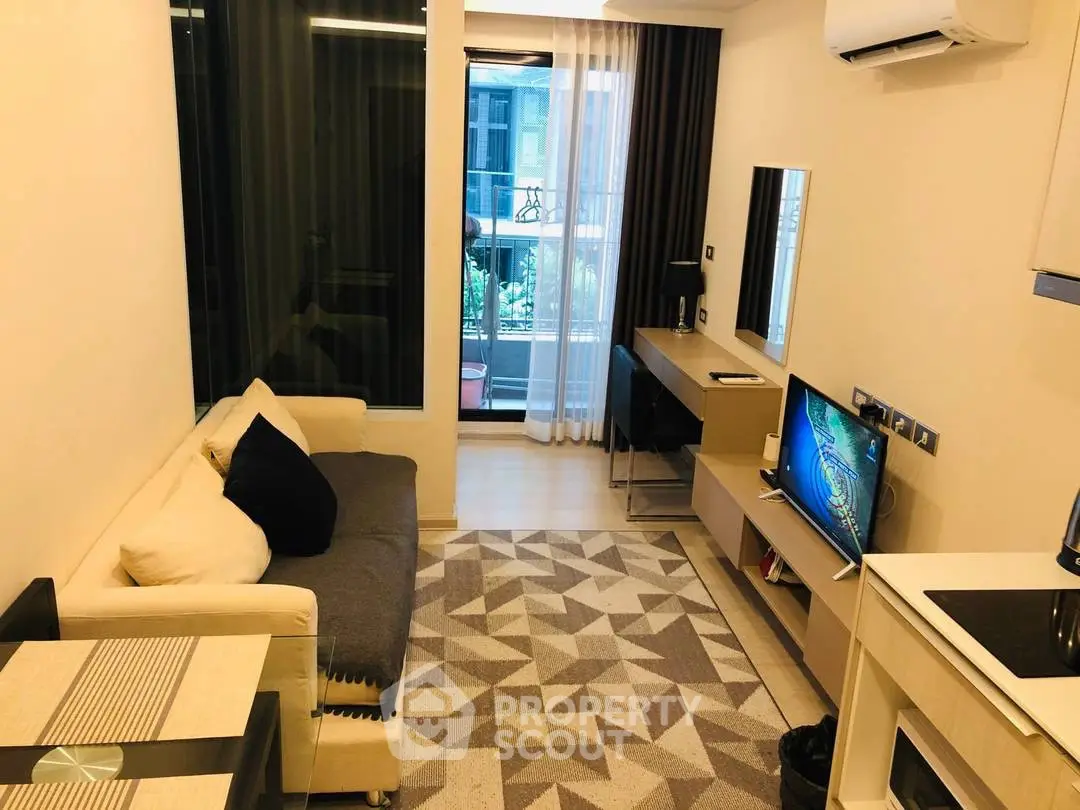 Modern living room with stylish decor and balcony view in a cozy apartment.