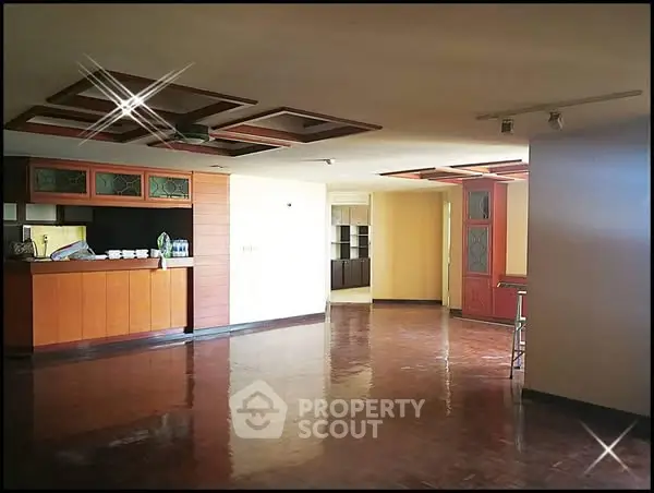 Spacious open-plan living area with polished floors and modern design.