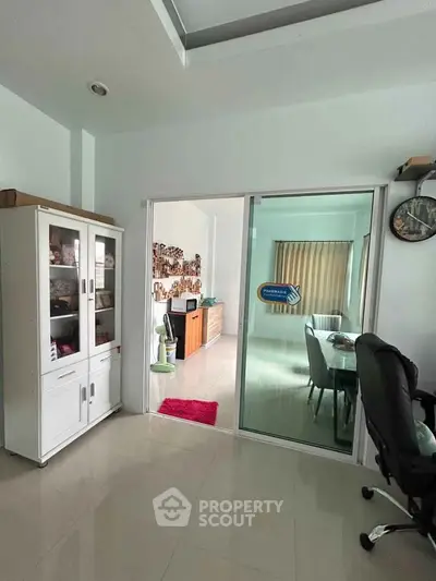 Spacious living area with sliding glass doors and modern furnishings