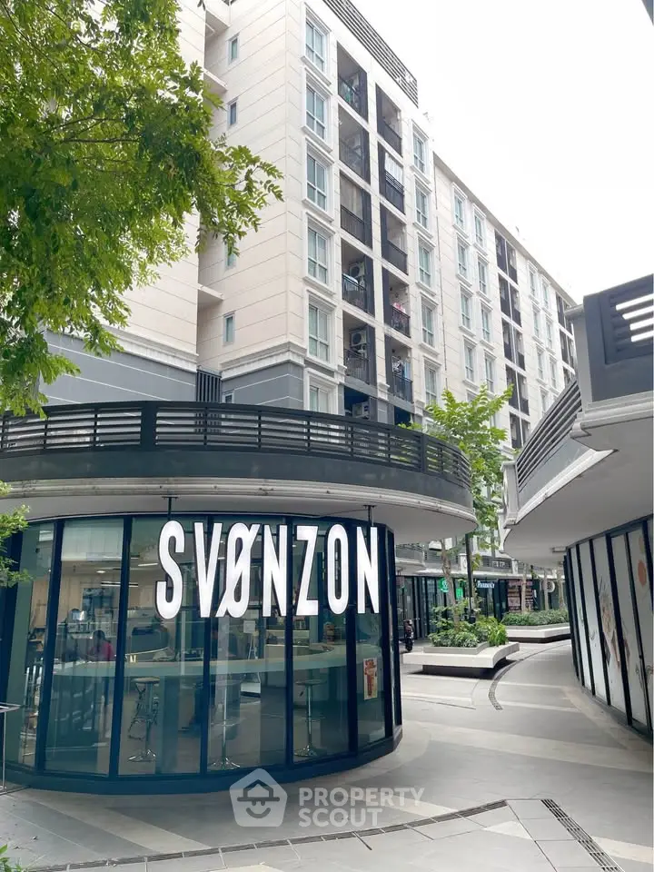 Modern commercial building with sleek design and large windows in urban setting.