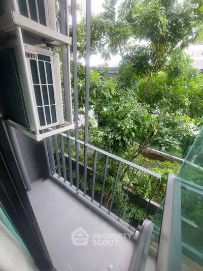 Charming small balcony with lush green views, perfect for relaxation and enjoying nature.