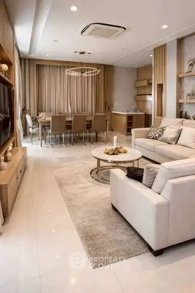 Luxurious open-plan living and dining area with elegant decor and modern furnishings.