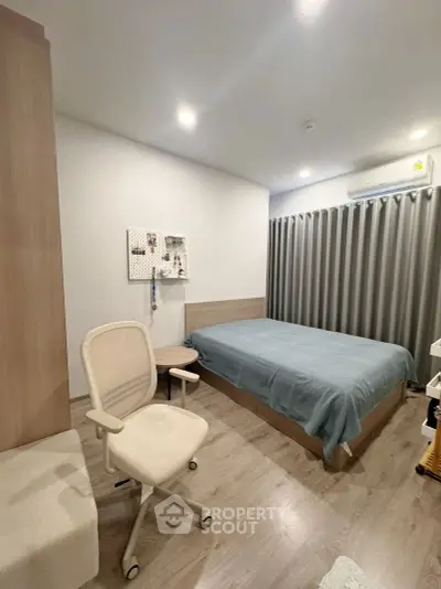 Modern bedroom with cozy decor and stylish furniture, perfect for relaxation and comfort.