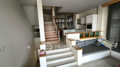 Spacious modern living area with open kitchen and stylish staircase