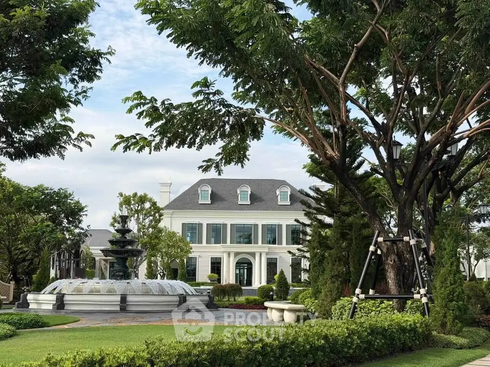 Elegant mansion with lush garden and fountain, showcasing luxury real estate charm.