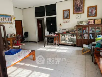 Spacious living room with vintage decor and ample natural light