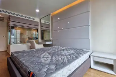 Modern bedroom with stylish decor and large windows in a luxury apartment.