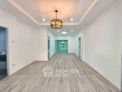 Spacious modern living room with elegant lighting and wooden flooring