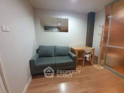 Cozy living room with modern sofa and study desk in stylish apartment.