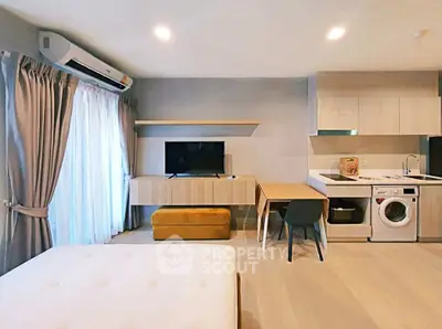 Modern studio apartment with open layout, featuring a cozy living area, dining space, and compact kitchen.