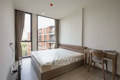 Modern bedroom with large window and stylish furniture in a high-rise apartment