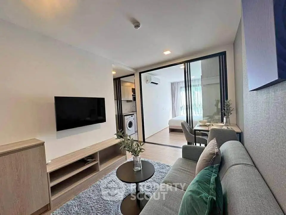 Modern living room with open layout and stylish decor in a contemporary apartment.
