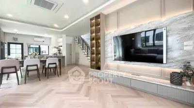 Luxurious open-plan living room with modern decor and stylish kitchen