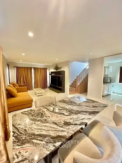 Spacious living room with elegant marble table and cozy seating area