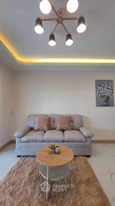 Modern living room with cozy sofa, stylish lighting, and elegant decor