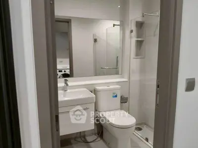 Modern bathroom with sleek fixtures and glass shower enclosure