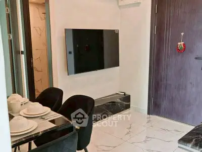 Modern apartment interior with sleek dining area and wall-mounted TV